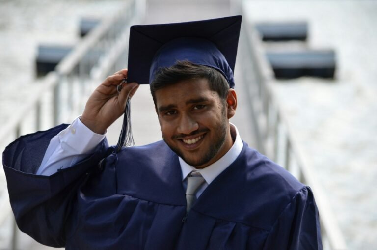 Indian graduate smiling in cap and gown
